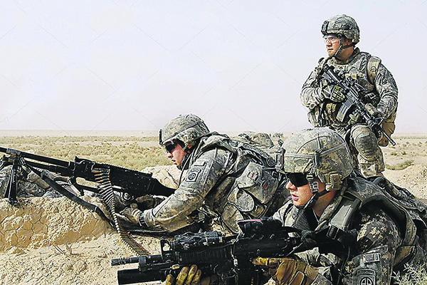 U.S. paratroopers position themselves to provide fire support for their fellow paratroopers and Iraqi national police officers as they prepare to clear a nearby village during Operation Winged Lion II, an Iraqi-led air assault mission in the Ma'dain region outside eastern Baghdad, Iraq, June 26, 2009. The paratroopers are assigned to the   82nd Airborne Division's Troop K, 5th Squadron, 73rd Cavalry.  Sgt. 1st Class Alex Licea