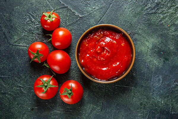 top view fresh red tomatoes with tomato paste on dark background bread burger snack meal fast-food breakfast photo food